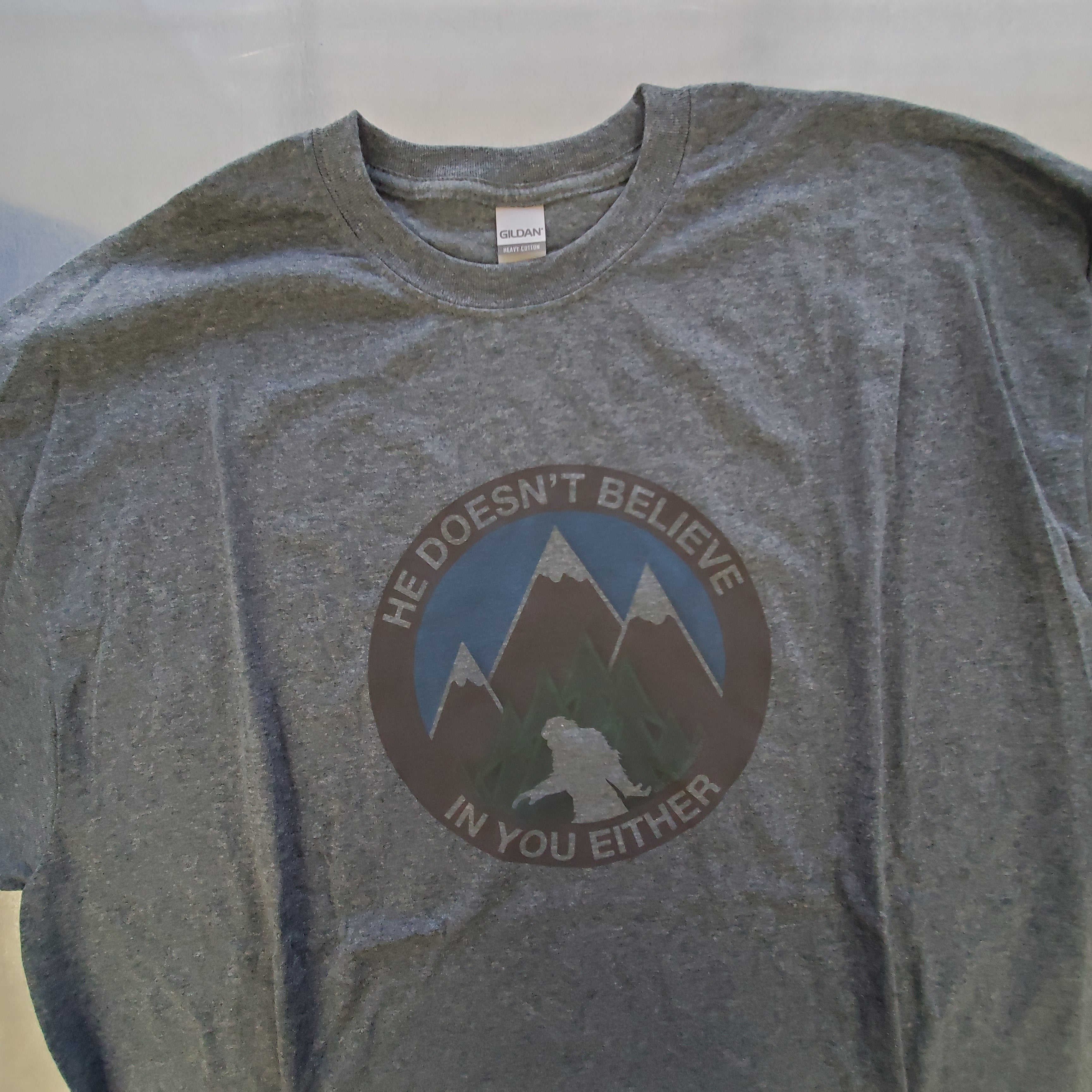 He Doesn't Believe In You Either Bigfoot T-shirts